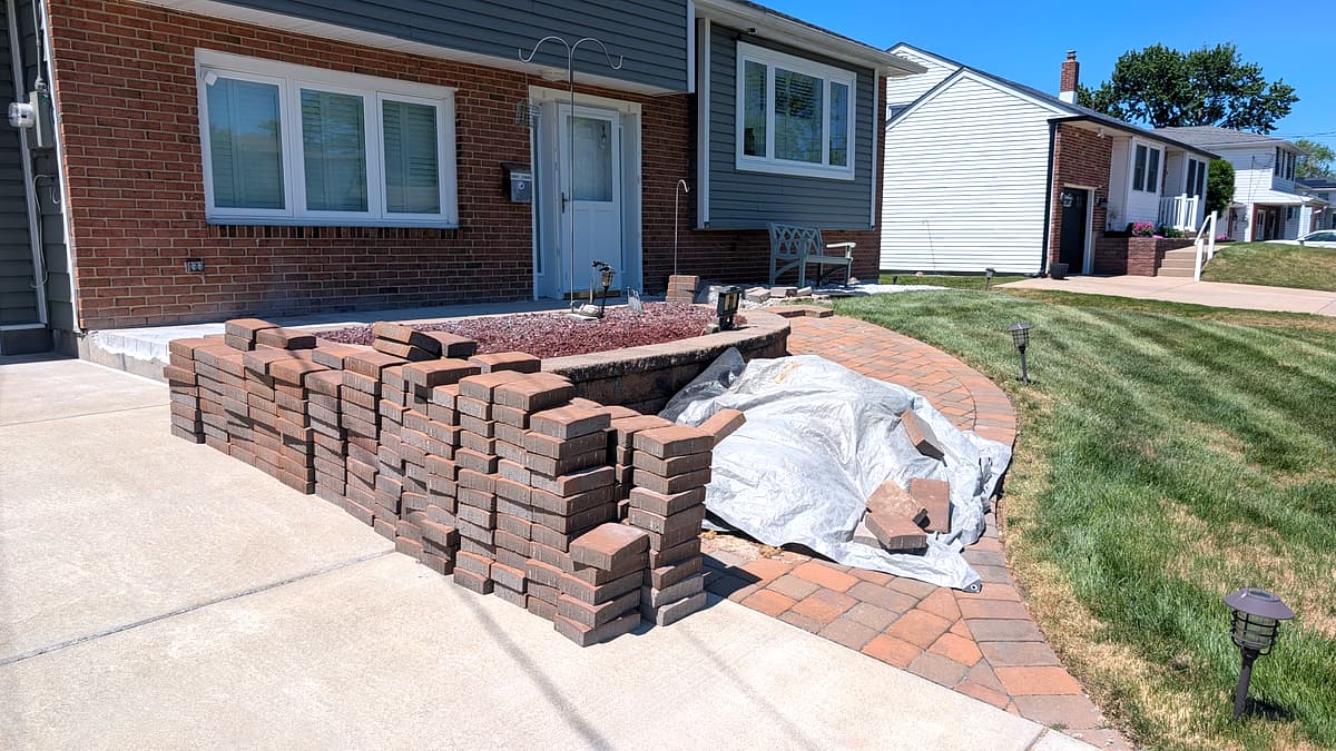 Curved paver walkway and raised paver planter bed at a Turnersville home